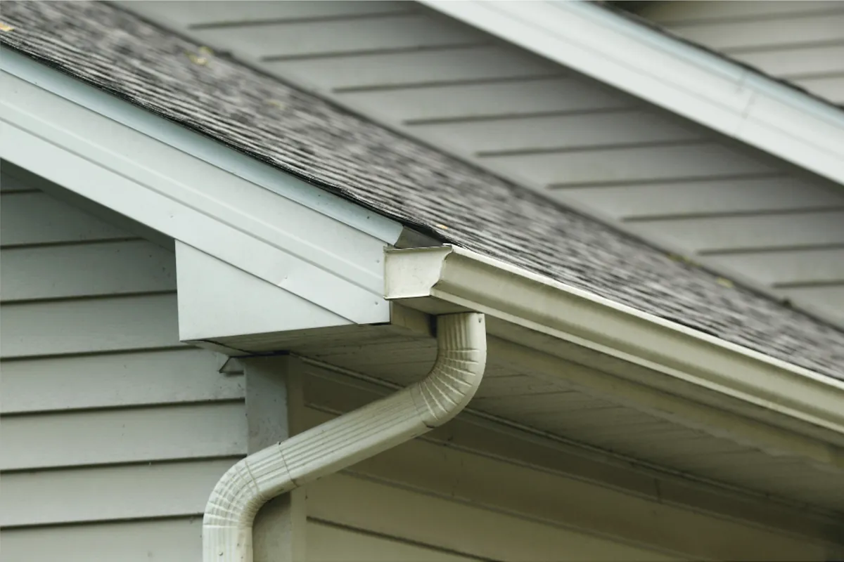 Downspout and splash block at the brick foundation of a Hampton, VA home